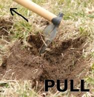 Grub hoe turning sod